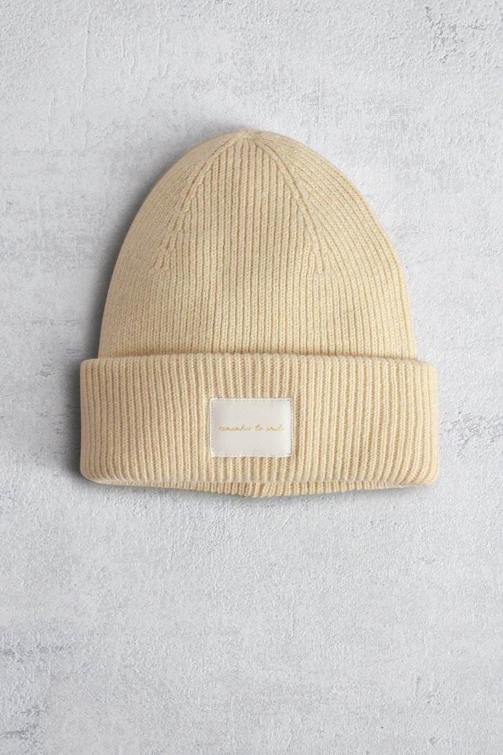 Le devant de Bonnet tricoté beige à inscription dorée de Liberty Island pour Femmes